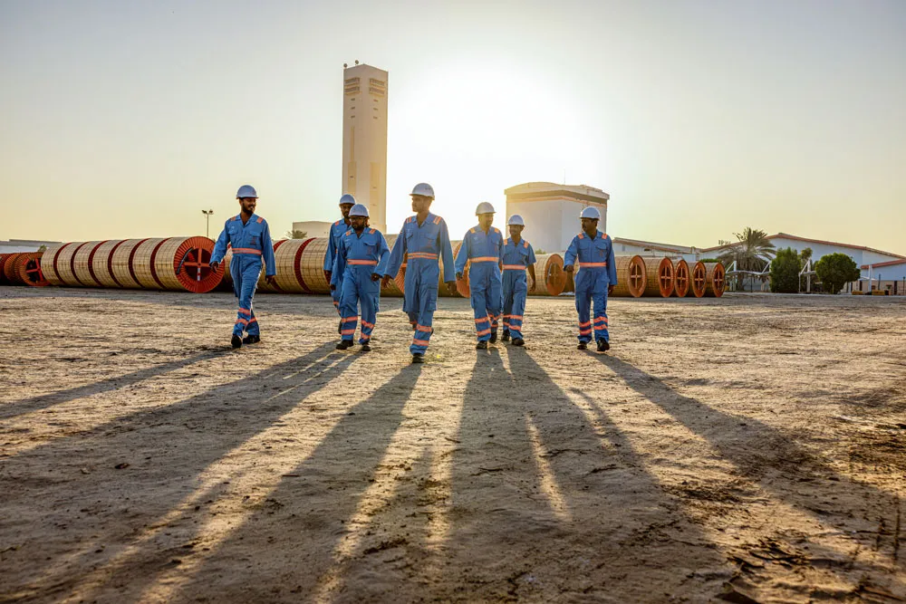 Ducab workforce walking through cable manufacturing yard